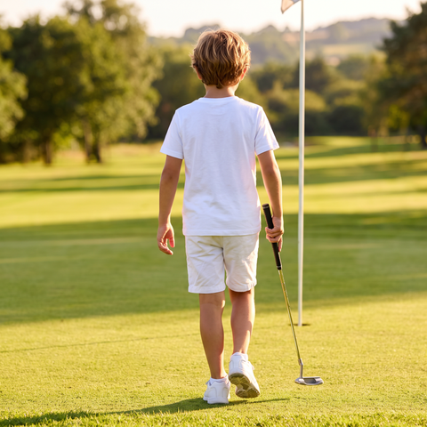 Kid walking to the flag in the Super Golfers T-shirt